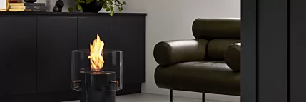 EcoSmart Fire Pillar 3T Designer Fireplace showcases a freestanding bioethanol column in an indoor private residence living area.