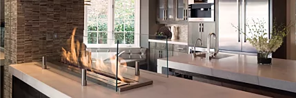 EcoSmart Fire XL900 Ethanol Burner creates a modern built-in fireplace for a private residence kitchen in the United States, enhancing the indoor space.