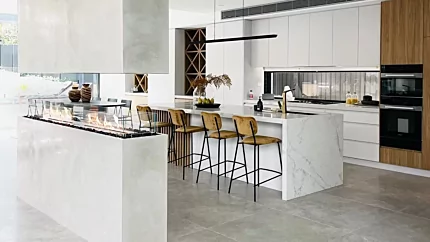 EcoSmart Flex 86IL Island Fireplace creates a contemporary ethanol fire feature on a kitchen island, blending warmth with residential design.