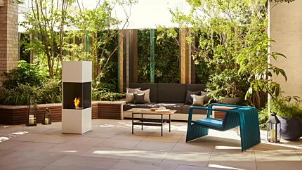 EcoSmart Fire Be Designer Fireplace adds clean bioethanol warmth to a white courtyard patio in Japan, freestanding outdoor centrepiece.