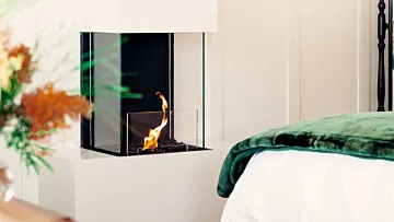 EcoSmart Fire Flex 18BY Bay Fireplace in Rosemont House Luxury B&B bedroom creates a luxurious indoor retreat with clean-burning ethanol and glass panels.